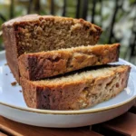 Delicious slices of moist banana bread stacked, with a pat of butter melting on top.